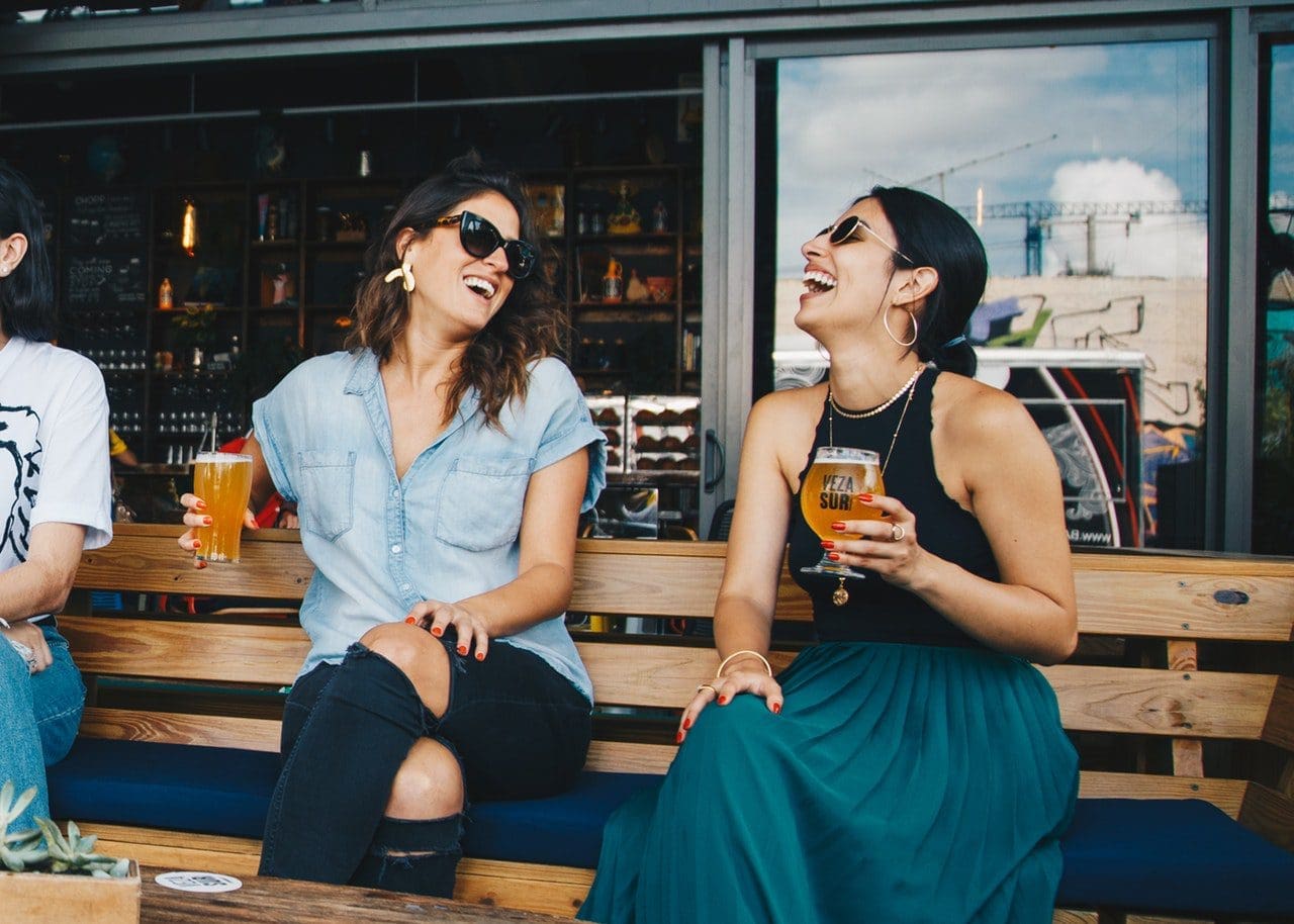 Women drinking beer on a patio photo for brand relevant email
