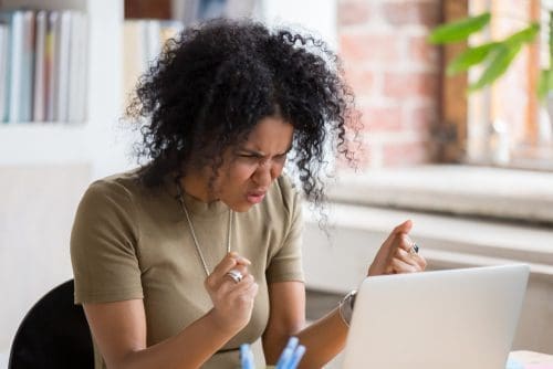 Woman angry at computer photo for when to respond post