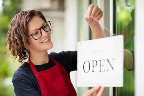 Woman opening bar photo for welcoming out-of-town guests post